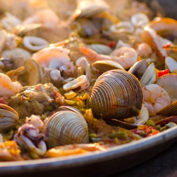El Paellero - Closeup of Paella with clams and calamari - Caterers Near Me El Paellero - Closeup of Paella with clams and calamari - Caterers Near Me