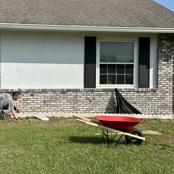 Casper Lawncare - a man with a wheelbarrow in front of a house - Lawn Services Near Me - Ocala, Florida Casper Lawncare - a man with a wheelbarrow in front of a house - Lawn Services Near Me - Ocala, Florida
