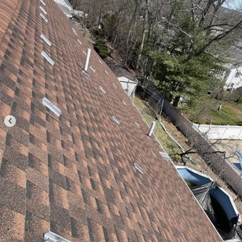Oakridge Resolutions - the roof of a house with a brown shingled roof - Solar Installation Near Me Oakridge Resolutions - the roof of a house with a brown shingled roof - Solar Installation Near Me
