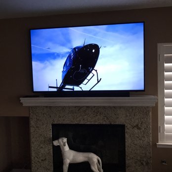 PURE HD Audio/Video Design - Mounted 60 inch Samsung 4K UHD Smart Tv over the fireplace with Samsung sound bar - Home Theatre Installation Near Me PURE HD Audio/Video Design - Mounted 60 inch Samsung 4K UHD Smart Tv over the fireplace with Samsung sound bar - Home Theatre Installation Near Me