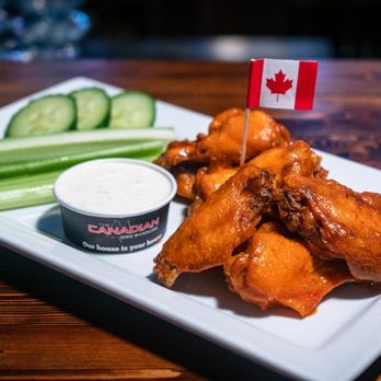 The Canadian Brewhouse - a plate of buffalo wings and a cucumber - Sports Bars Near Me - London, Ontario The Canadian Brewhouse - a plate of buffalo wings and a cucumber - Sports Bars Near Me - London, Ontario