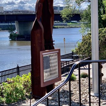 Max410 at The Waters Edge - a statue of a woman holding a suitcase - Seafood Near Me - Glenville, New York