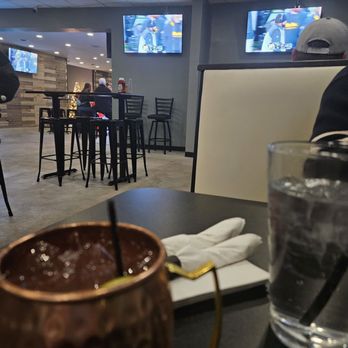 The Village TapHouse - A Moscow Mule and a view of three of the numerous TVs. - Bars Near Me - Pittsburgh, Pennsylvania