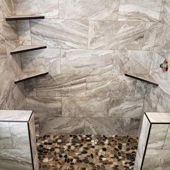 Inex Construction - a walk - in shower with a stone floor - General Contractors Near Me Inex Construction - a walk - in shower with a stone floor - General Contractors Near Me