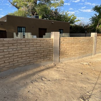 Tip Top - a brick wall and a concrete fence - Landscaping Near Me