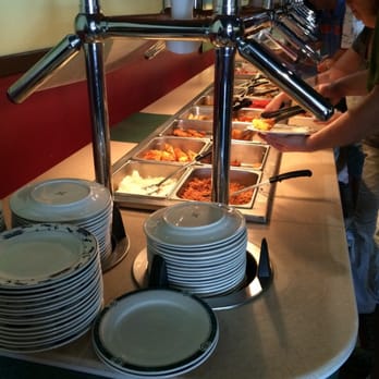 China Fair Restaurant - a woman serving food to a group of people - Chinese Near Me - Traverse City, Michigan China Fair Restaurant - a woman serving food to a group of people - Chinese Near Me - Traverse City, Michigan
