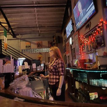 The Tavern - a woman standing at the bar - American Near Me - Durham, North Carolina