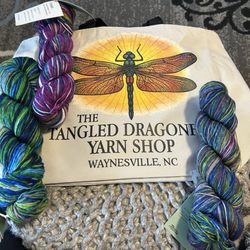 Shop bag and three skeins of Urth yarn.