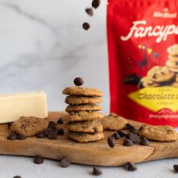 Fancypants Baking - Crispy Fancypants Chocolate Chip cookies stacked with falling chocolate chips, made with real butter and premium ingredients.