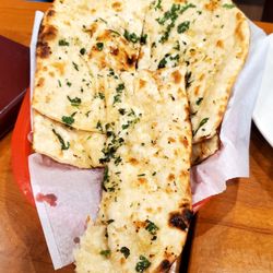 Village Tandoor - North Indian restaurant - Butter garlic naan (with one piece missing because my daughter couldn't wait to eat it, lol)