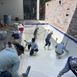 Bluebonnet Custom Pools and Modern Method installing Pebble Tec plaster custom Pools downtown Houston