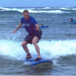 Aloha Surf Lessons - Catching a Wave at Poipu Beach in Kauai, HI.