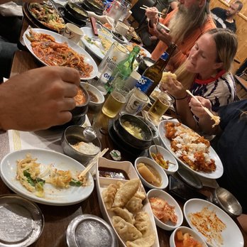 Seoul Garden - a table full of food and people eating - Korean Near Me - Parma, Ohio Seoul Garden - a table full of food and people eating - Korean Near Me - Parma, Ohio