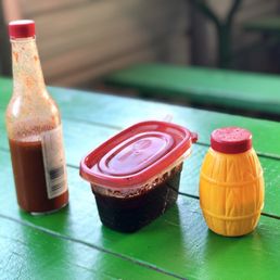 a hot sauce and a bottle of ketchup a hot sauce and a bottle of ketchup