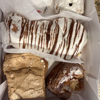 Peterson's Donut Corner - That's a frosted Cruller,  a zebra tail, a maple pillow, and what's left of a glazed pillow. These are fantastic.! - Donuts Near Me - Escondido, California
