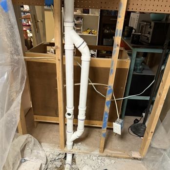 Clover Plumbing - Installing the plumbing for a vanity and a kitchen sink on the other side of the wall. - Plumbing Near Me - Hiram, Georgia
