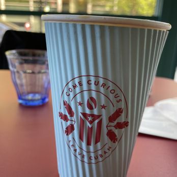 Colada Shop - a paper cup on a table - Coffee & Tea Near Me - Washington, DC, District of Columbia