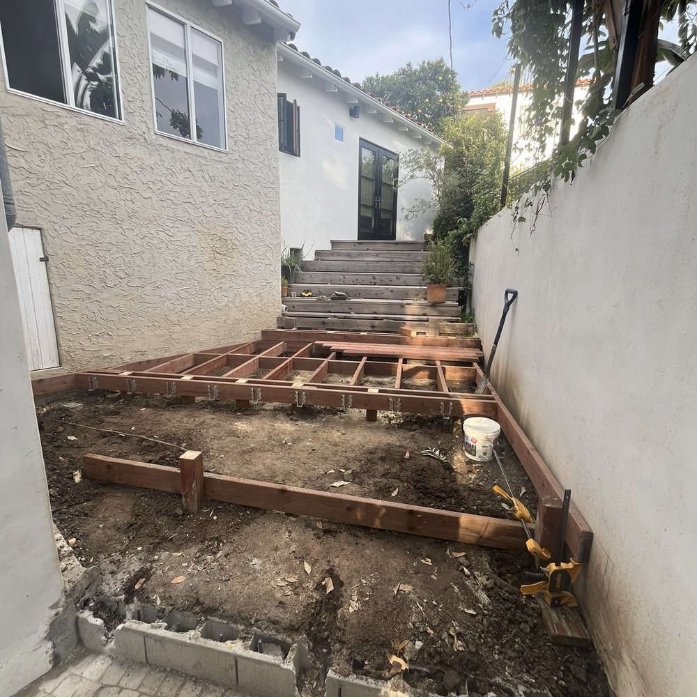 Jack Mazur - Beginning stages of framing the ground level deck. Old redwood deck pre-demo. - Carpenters Near Me