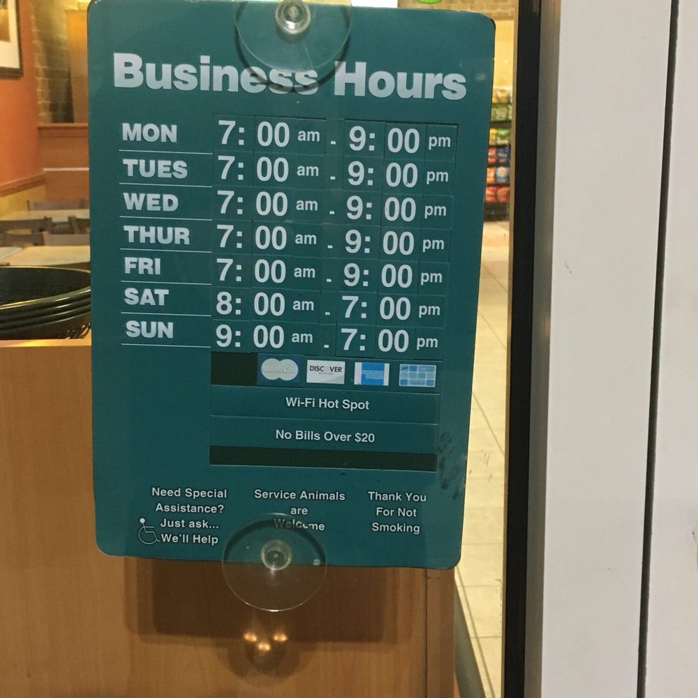 a business hours sign in a subway