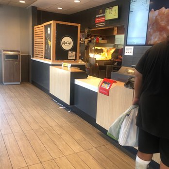 McDonald's - a man standing at the counter - Burgers Near Me - Coffeyville, Kansas
