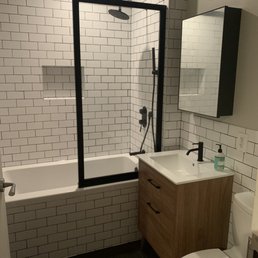 a bathroom with a toilet, sink, and bathtub