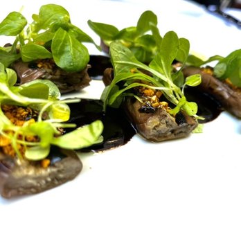 Saint Theo's - Charred eggplant with black garlic glaze, spicy hazelnuts, and mache - Italian Near Me - New York, New York Saint Theo's - Charred eggplant with black garlic glaze, spicy hazelnuts, and mache - Italian Near Me - New York, New York