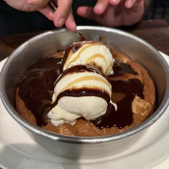 Trident Grill II - Fresh out of the oven,  pan sized, chocolate chip cookie with vanilla bean ice cream and chocolate syrup - Seafood Near Me - Tucson, Arizona