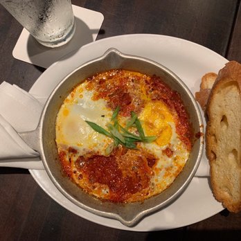 The General Public - Shakshuka (crushed tomatoes, toasted cumin, smoked paprika, poached eggs served with a toasted baguette) - New American Near Me - Houston, Texas The General Public - Shakshuka (crushed tomatoes, toasted cumin, smoked paprika, poached eggs served with a toasted baguette) - New American Near Me - Houston, Texas