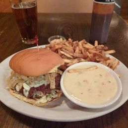 Not on the menu, but single cheese burger, sun Bleu cheese and add onion straws. Fries with queso side