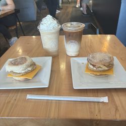 Centurion Coffee - Coffe frappe, Carmel latte macchiato, and sausage egg and cheese on an English muffin