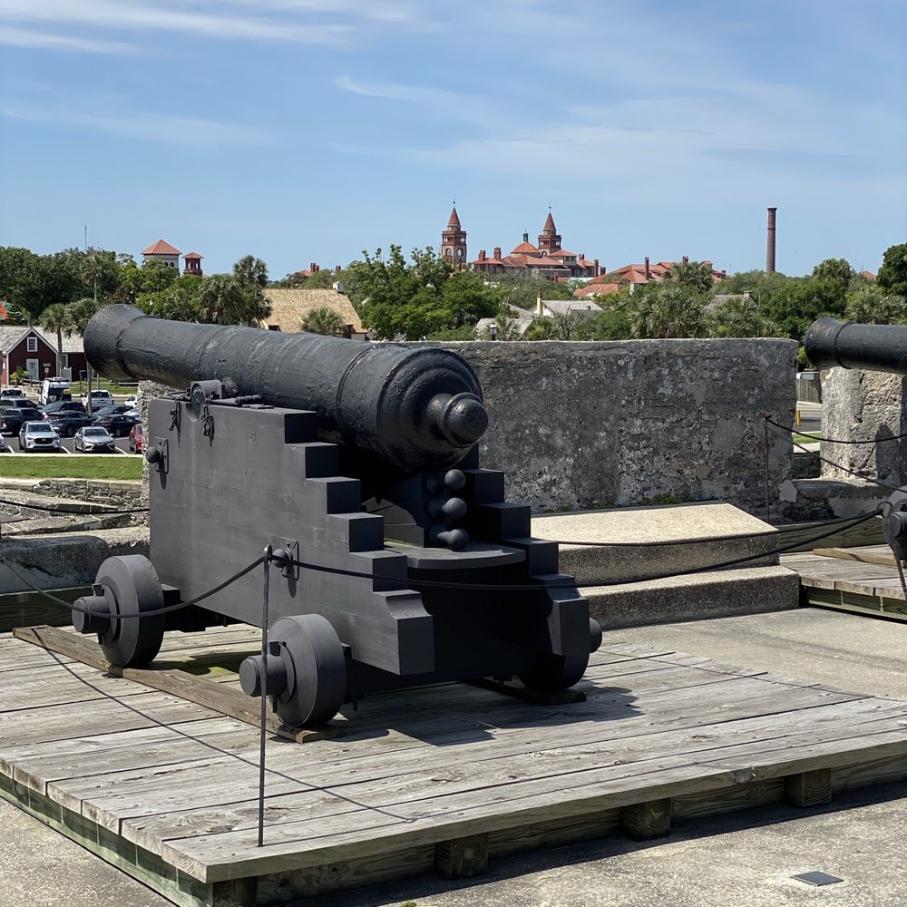 City of St Augustine - Fort cannons with a Church in the background - Landmarks & Historical Buildings Near Me - Saint Augustine, Florida