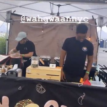 Wah Gwaan - two men preparing food under a tent - Food Trucks Near Me - Brooklyn, New York Wah Gwaan - two men preparing food under a tent - Food Trucks Near Me - Brooklyn, New York
