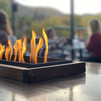 Rooftop Tavern - a fire pit with people in the background - Pubs Near Me - Morrison, Colorado