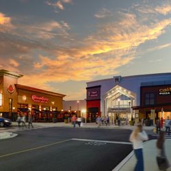 Annapolis Mall - Shoppers walk outside Annapolis Mall at sunset near The Cheesecake Factory and California Pizza Kitchen.