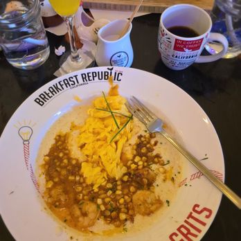 Breakfast Republic - Shrimp & grits, prosecco mimosa and cafe de olla. in the background is the bacon mac n cheese. - Breakfast & Brunch Near Me - Costa Mesa, California