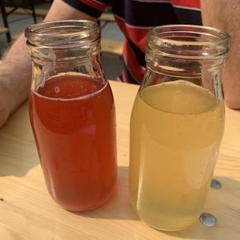 Farmhaus Cider Co. - Lake Effect on the left and Skinny Dip Sunset on the right - Cideries Near Me - Hudsonville, Michigan Farmhaus Cider Co. - Lake Effect on the left and Skinny Dip Sunset on the right - Cideries Near Me - Hudsonville, Michigan