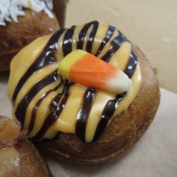 Da Vinci's Donuts - Halloween special doughnut with orange icing, chocolate drizzle, and candy corn. - Donuts Near Me - Sandy Springs, Georgia Da Vinci's Donuts - Halloween special doughnut with orange icing, chocolate drizzle, and candy corn. - Donuts Near Me - Sandy Springs, Georgia