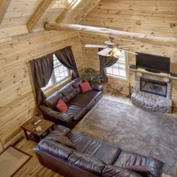 Pine Hill Lodge - Main floor living room w/ a wood burning fireplace. View is from the top floor which includes 2 bedrooms, 1 bath and pull out sofa in loft.