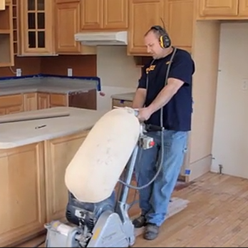 Fillbach Wood Floors - a man using a vacuum cleaner - Flooring Near Me Fillbach Wood Floors - a man using a vacuum cleaner - Flooring Near Me