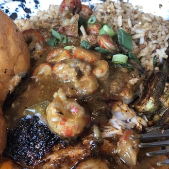 Tricky Fish - Blackened Redfish peaking out under the tasty crawfish etouffée. - Seafood Near Me - Fort Worth, Texas