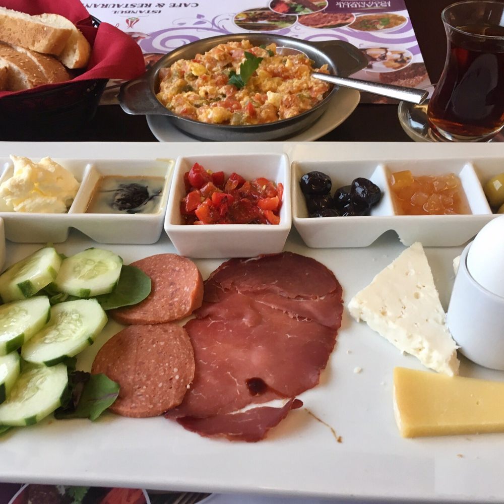 Istanbul breakfast plate and menemen with fresh hot bread and tea. Istanbul breakfast plate and menemen with fresh hot bread and tea.