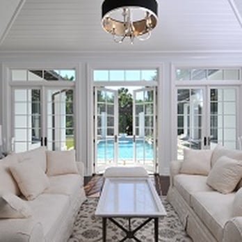 Nautilus Homes - a living room with a pool in the background - General Contractors Near Me - Sarasota, Florida Nautilus Homes - a living room with a pool in the background - General Contractors Near Me - Sarasota, Florida