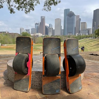 REB - Onewheel's chilling in front of the Houston Skyline at Eleanor Tinsley Park - Bike Rentals Near Me - Houston, Texas