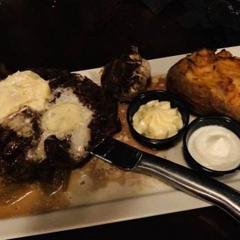 Gregory’s Steak & Seafood Grille - Delmonico atop grilled onions with blue cheese butter and twice baked potato - Seafood Near Me - Cocoa Beach, Florida