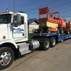 Rent Rite Equipment - Semi with JLG scissor lift and boom lift.