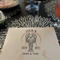 The take out container for the Jack's Surg and Turf lobster roll with Side Salad