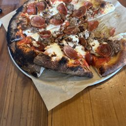 Pizza mushroom pepperoni ans sausage with cheese crust is burnt