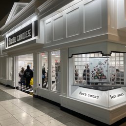 a storefront with people walking by
