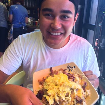 Snooze, an A.M. Eatery - Happy ASU student with soon to be devoured spud. - Breakfast & Brunch Near Me - Tempe, Arizona Snooze, an A.M. Eatery - Happy ASU student with soon to be devoured spud. - Breakfast & Brunch Near Me - Tempe, Arizona