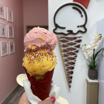 Sugar Ice Cream & Waffles - Scoop of strawberry and mango with sprinkles in a red velvet cone - Desserts Near Me - McKinney, Texas